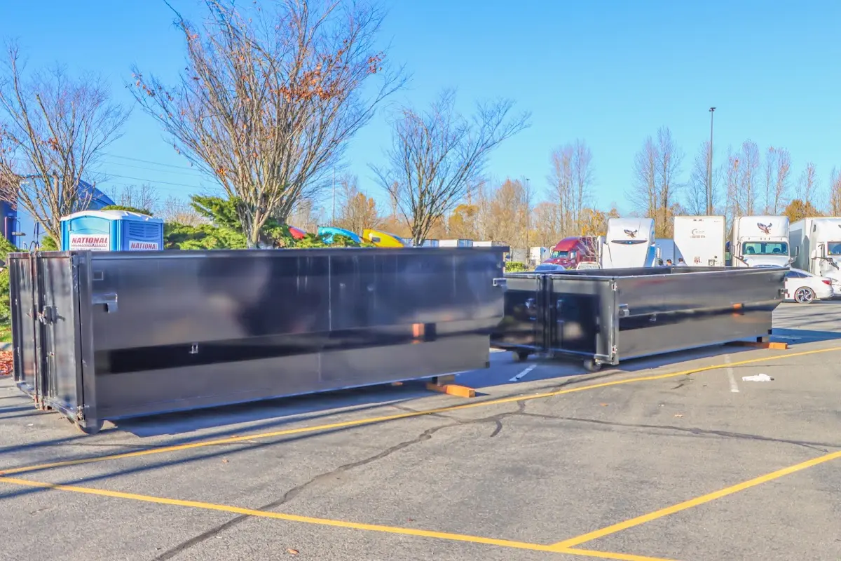 Professional dumpster rental service with roll-off container on residential driveway in Offutt AFB